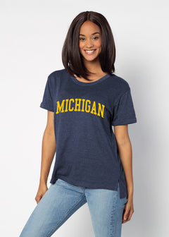 Michigan Wolverines Women's Navy Relaxed Melange light-weight cotton-poly  with Ribbed scoop neck, short rolled sleeves, and a longer back hem for extra coverage.