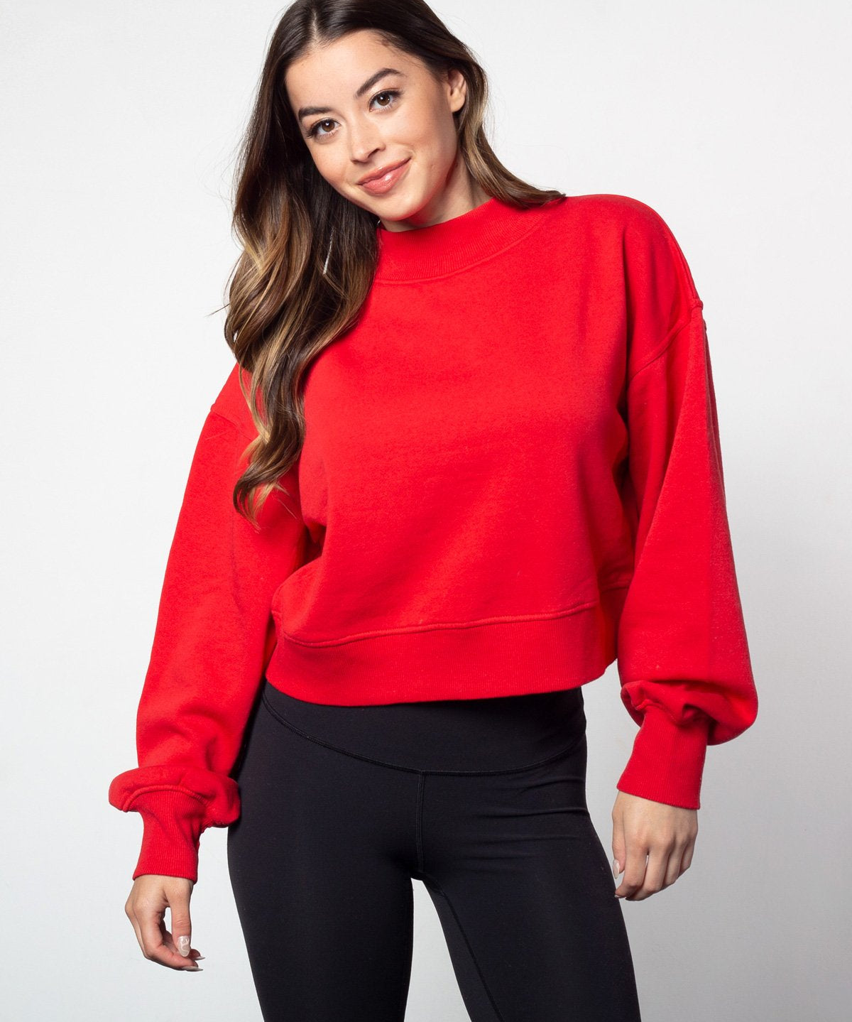 Red mockneck sweatshirt with dropped shoulders, balloon sleeves, ribbed neck, sleeves and hem. Cropped relaxed silhouette