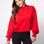 Red mockneck sweatshirt with dropped shoulders, balloon sleeves, ribbed neck, sleeves and hem. Cropped relaxed silhouette