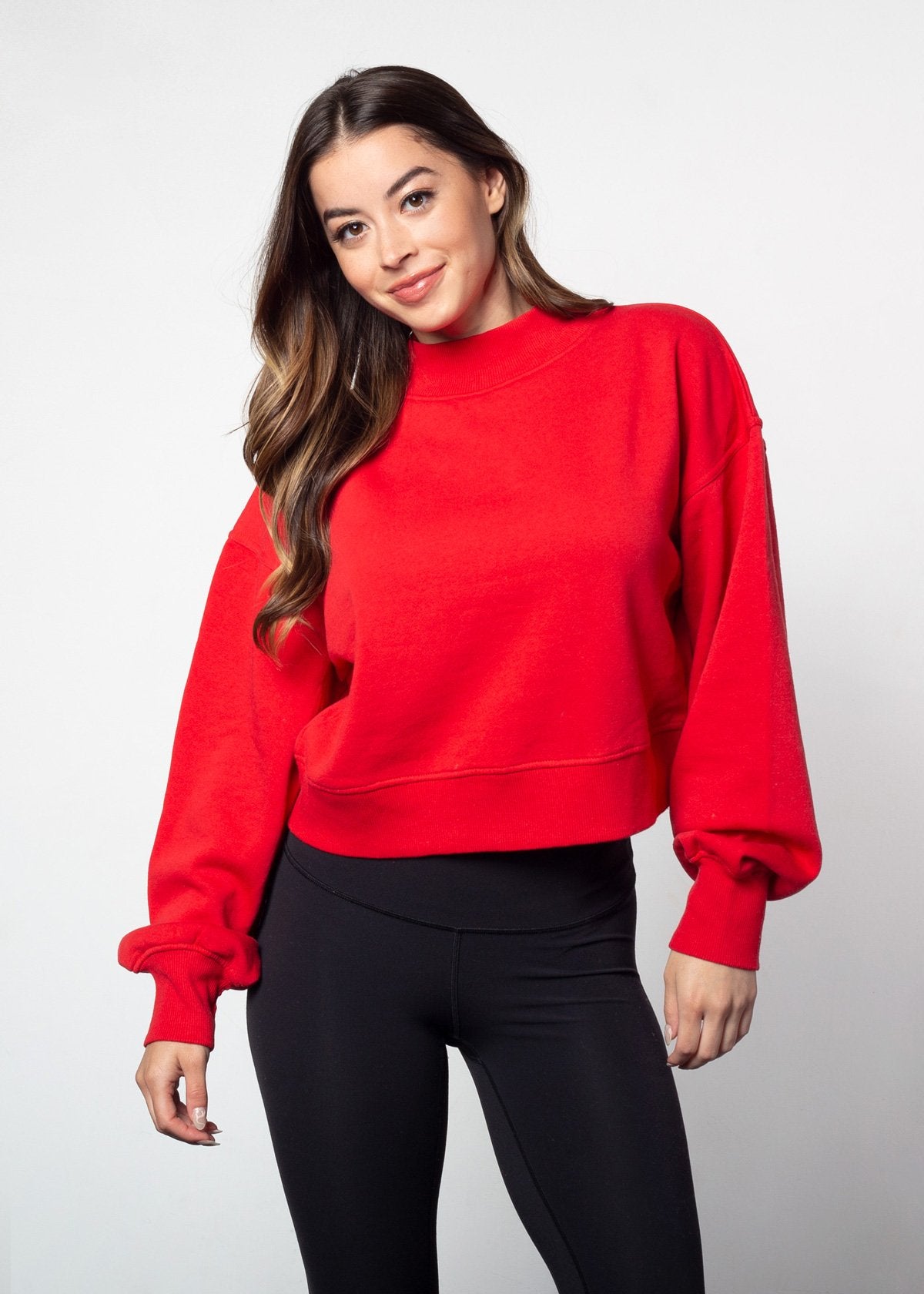 Red mockneck sweatshirt with dropped shoulders, balloon sleeves, ribbed neck, sleeves and hem. Cropped relaxed silhouette