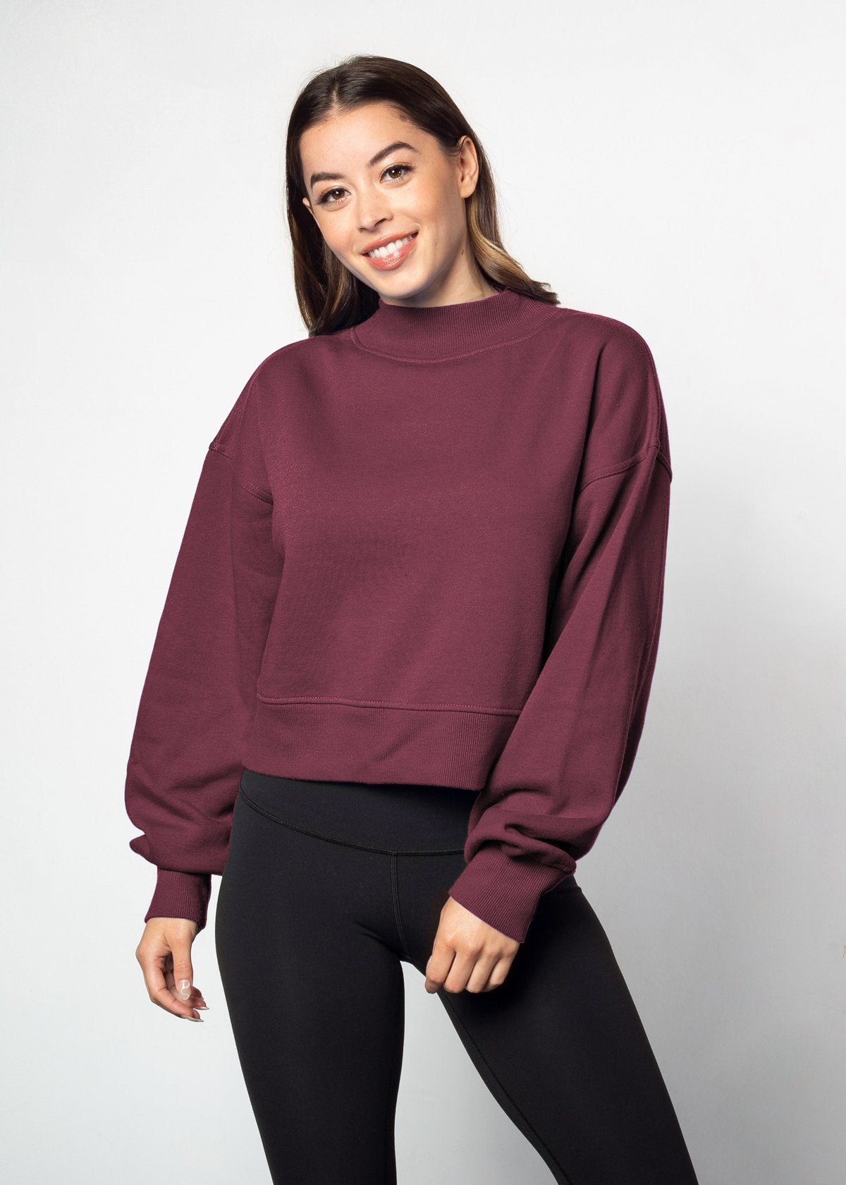 Maroon mockneck sweatshirt with dropped shoulders, balloon sleeves, ribbed neck, sleeves and hem. Cropped relaxed silhouette