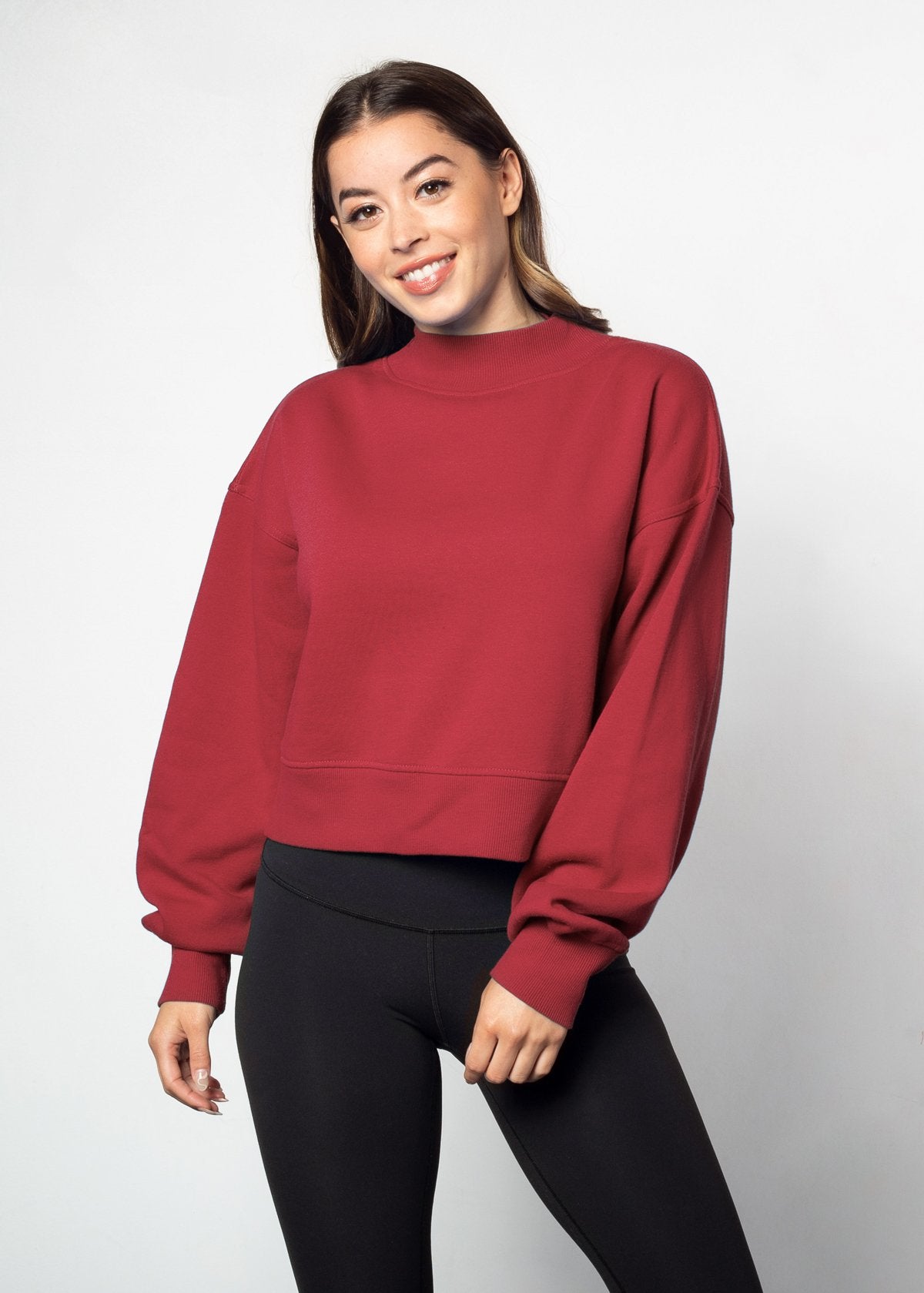 Crimson mockneck sweatshirt with dropped shoulders, balloon sleeves, ribbed neck, sleeves and hem. Cropped relaxed silhouette