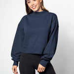 Navy mockneck sweatshirt with dropped shoulders, balloon sleeves, ribbed neck, sleeves and hem. Cropped relaxed silhouette