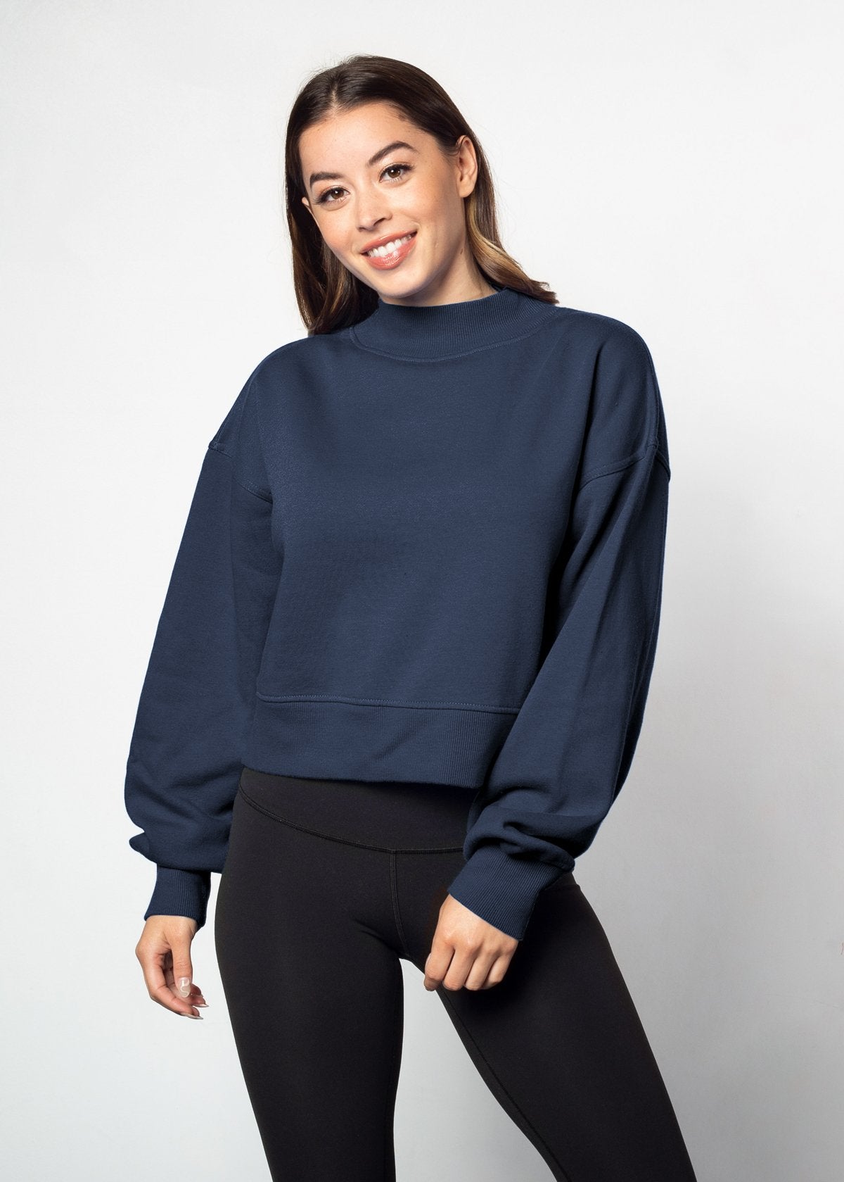 Navy mockneck sweatshirt with dropped shoulders, balloon sleeves, ribbed neck, sleeves and hem. Cropped relaxed silhouette