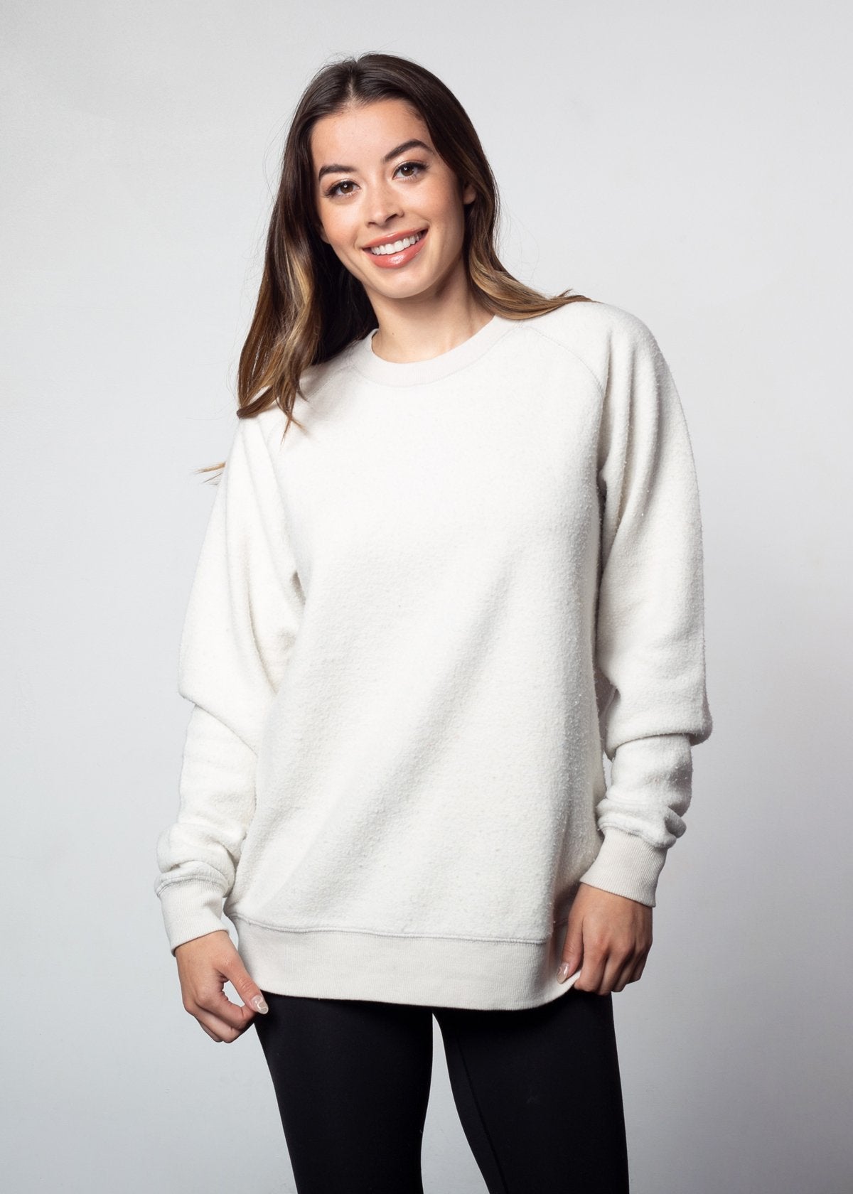 White womens crew sweatshirt with ribbed crew neck, raglan sleeves and hem.